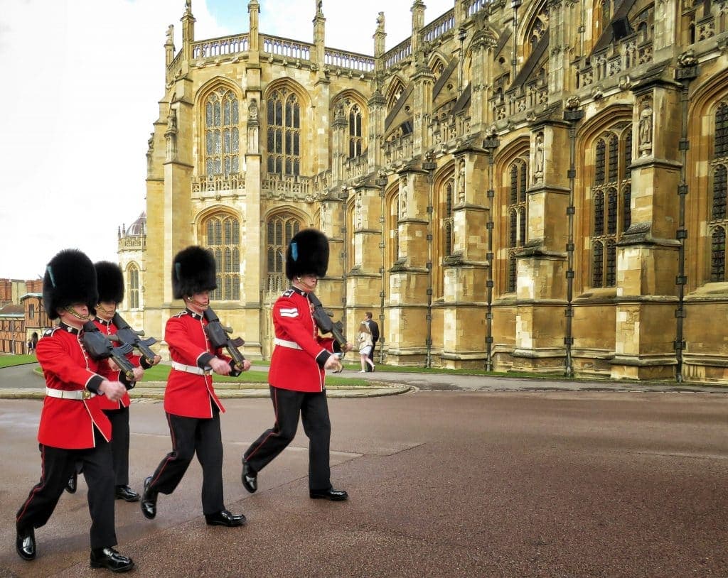 Red Uniformed guardsmen march before the Queen of England arrives to Sunday Easter Service at Windsor Palace in London, United Kingdom