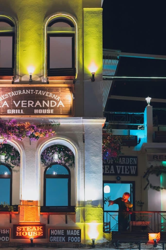 Colorfully Illuminated Restaurant Facade at Night in Rhodes, Greece